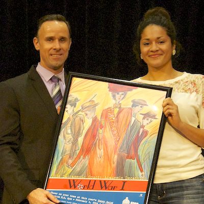 Craig Irish presents framed poster to student artist