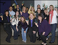 Group of Teachers of the Year holding up glass trophies