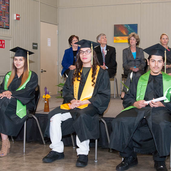 Graduates seated in front of stage