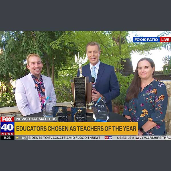 Teachers with KXTV reporter on patio set