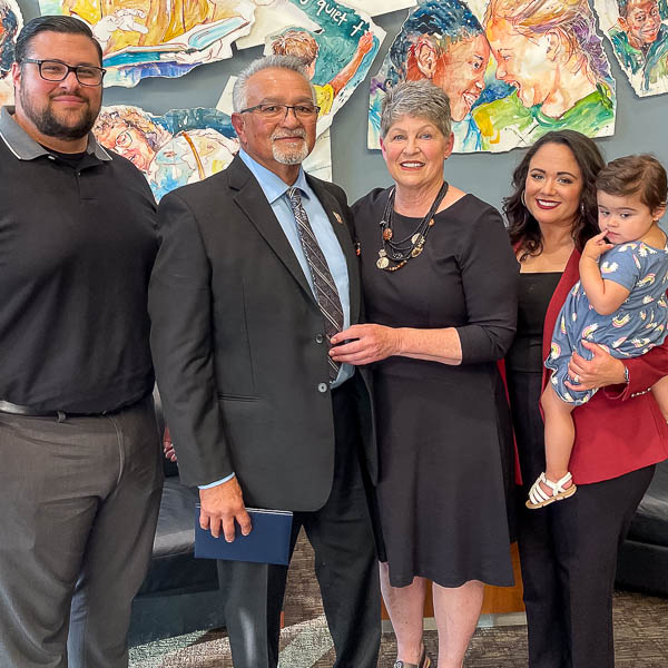 Lou Soto posing with family members