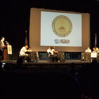 Wide shot of stage with competitors testing