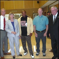 Superintendent posing with administrators and Daniel Watts