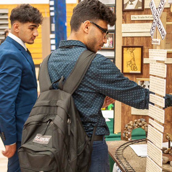 Students reading presentation boards