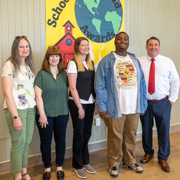 Staff posing with student