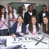 Students passing out txtng kills pledge thumb bands