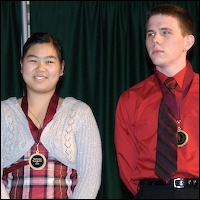 Medal recipients smiling on-stage