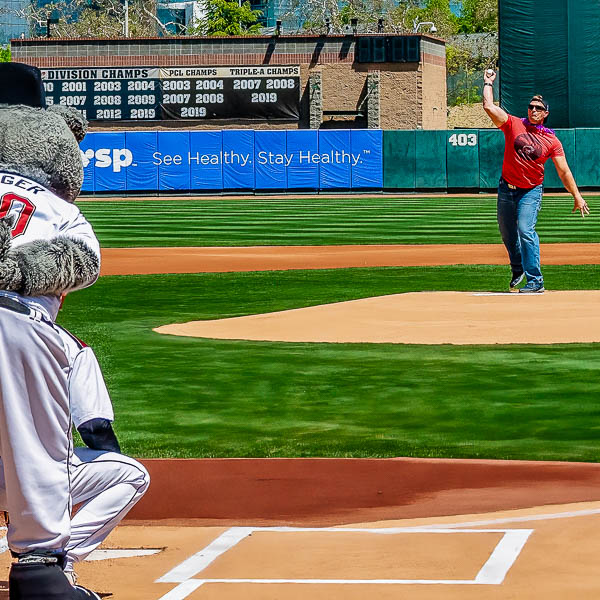 Teacher throwing baseball