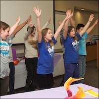 Students dancing with arms raised