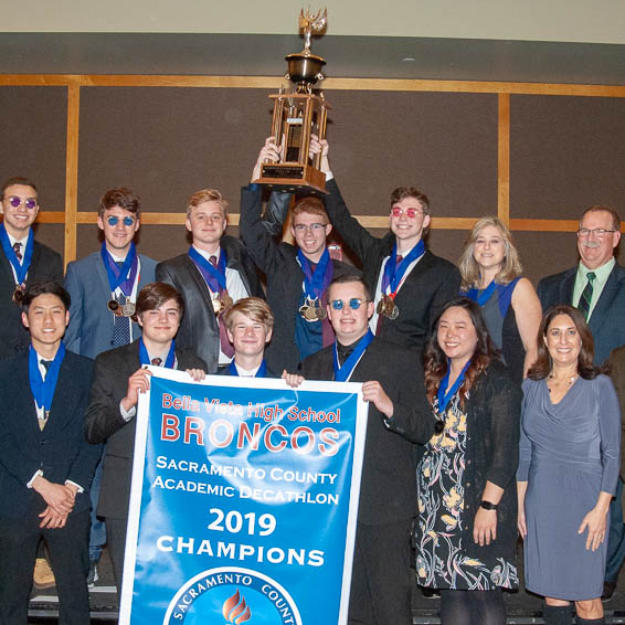 Bella Vista team posing with trophy and banner