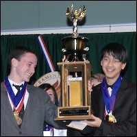 Students holding large trophy