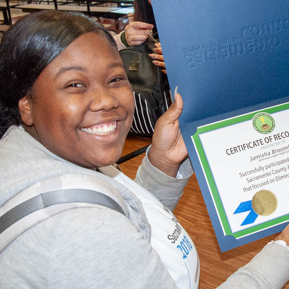 Student holding certificate