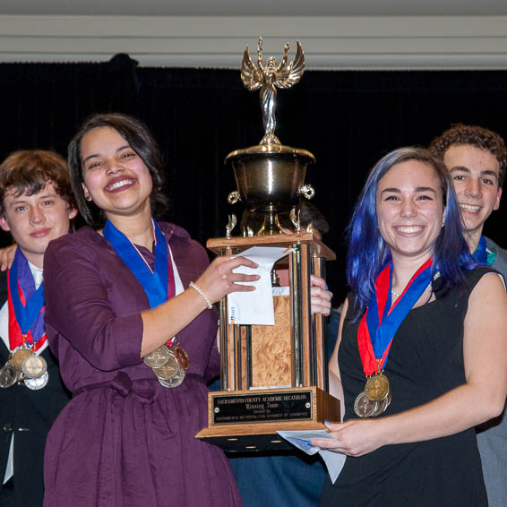 Students holding large trophy