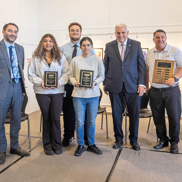 Jeilene Garcia, Kadie Reynosa Martinez, and Joshua McCarthy posing with dignitaries