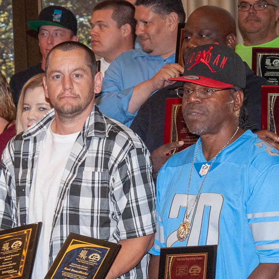 Clients holding plaques