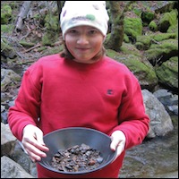 Student holding gold pan