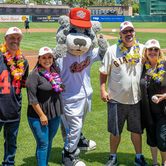 Employees posing on-field with River Cats mascot