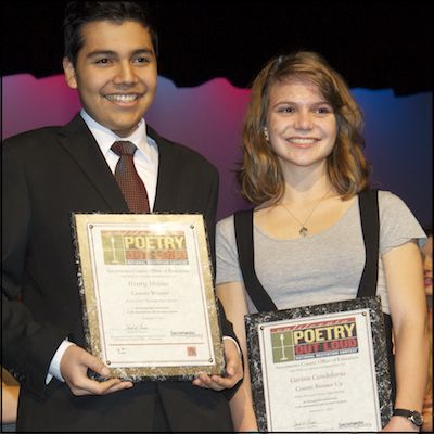 Henry Molina and Carinn Candelaria holding plaques