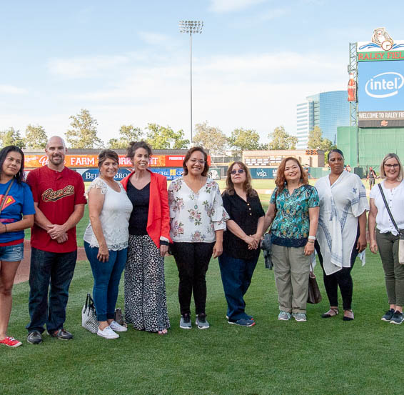 Classified education employees being recognized on-field