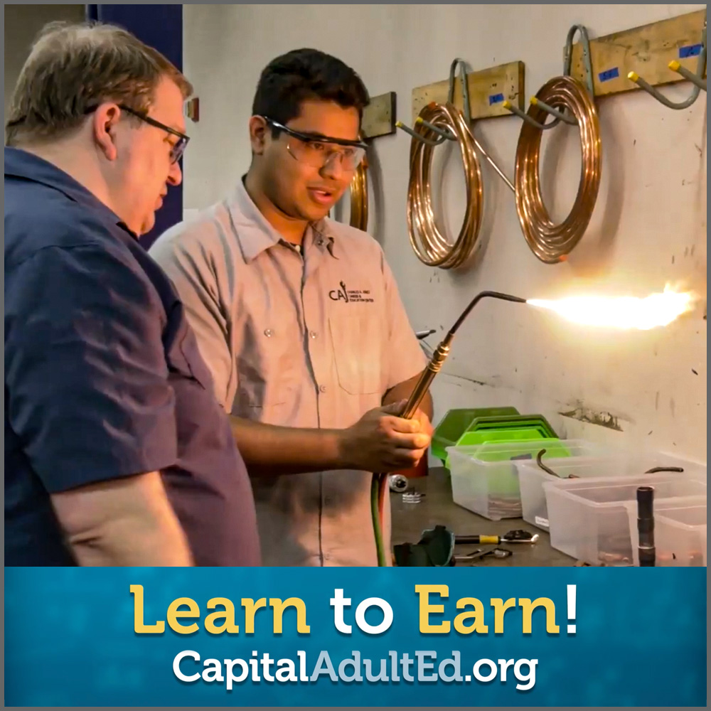 Educator teaching a student how to weld
