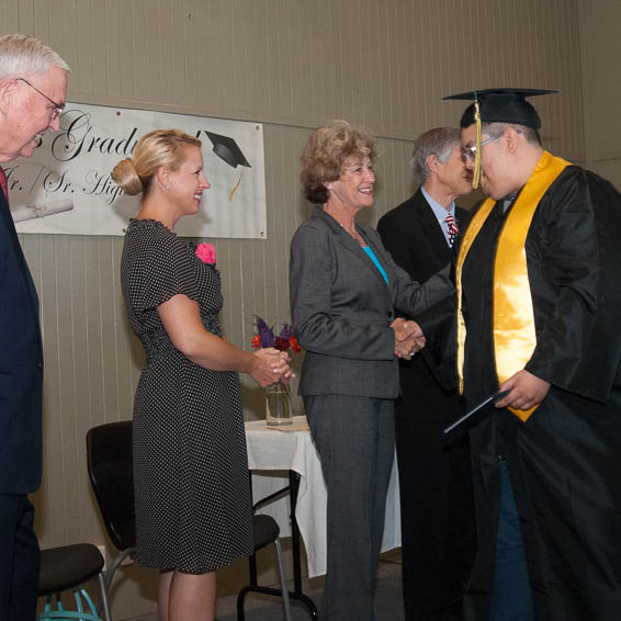 Graduate shaking hands of Board members