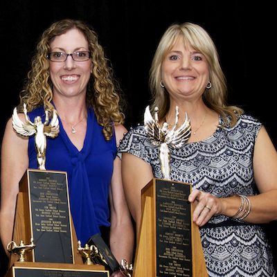 Jennifer Walker and Michelle Bebout holding trophies.