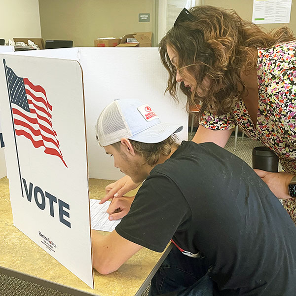 Teacher helping student with ballot