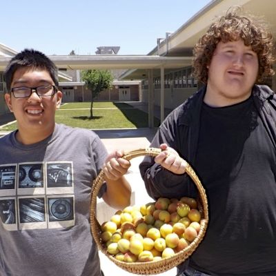 Students holding basket of fruit