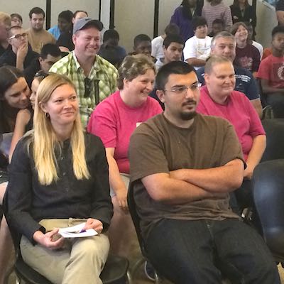 Seated audience, smiling