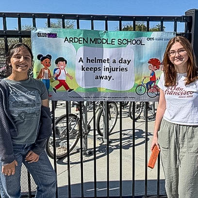 Student posing in front of sign
