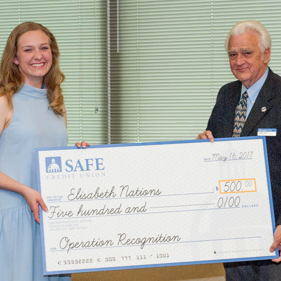 Elisabeth Nations receiving large check from Herb Long