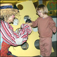 Clown entertaining young child