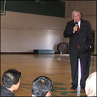 David W. Gordon speaking in gymnasium