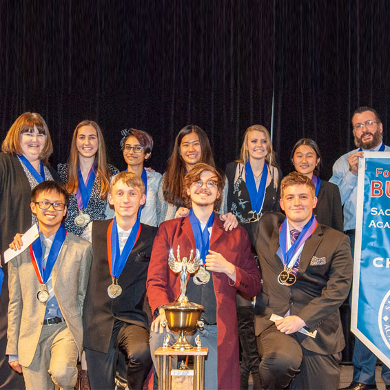 Folsom HS team with banner and trophy