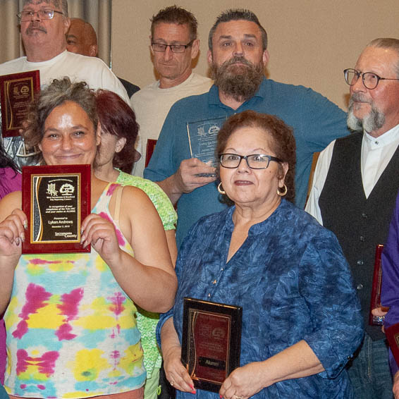 Clients holding plaques