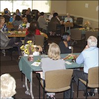 Wide shot of teachers seated at reception