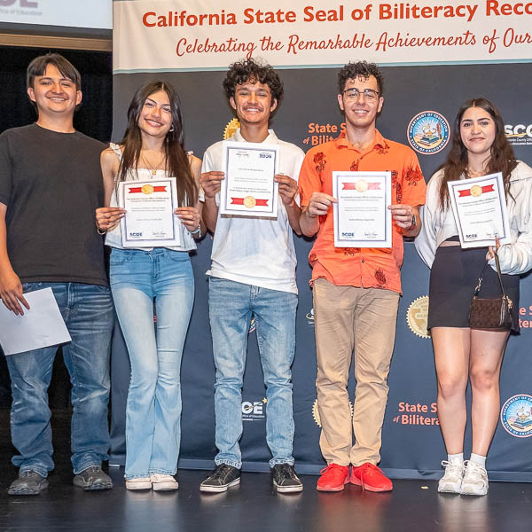 Students posing with certificates