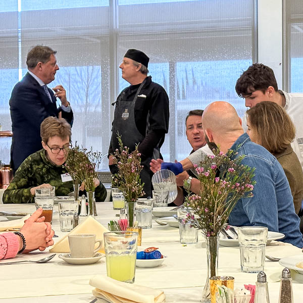 Student serving food to guests
