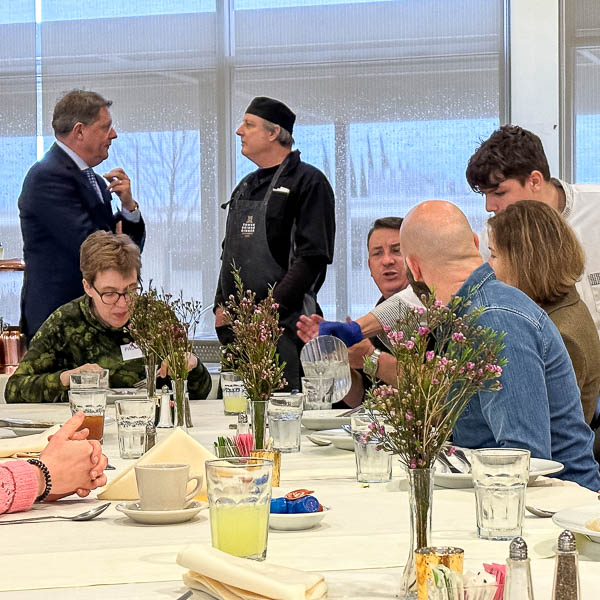 Student serving food to guests