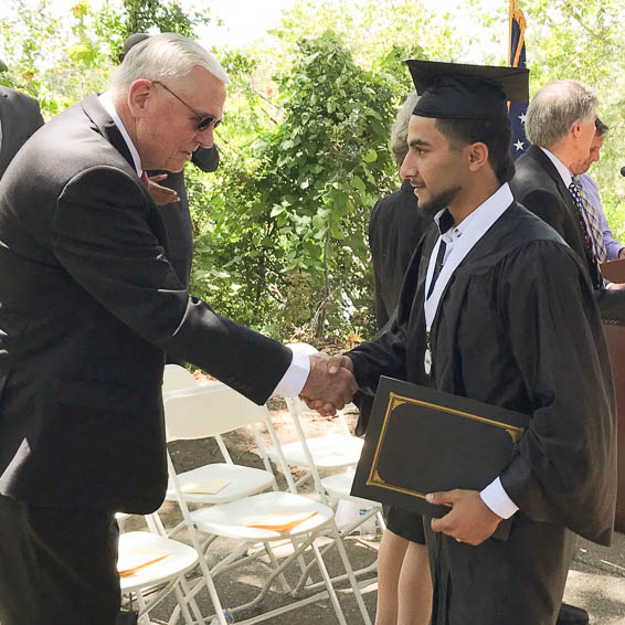 Superintendent shaking graduate's hand