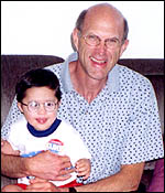 Michael Bernardis holding 3-year-old child