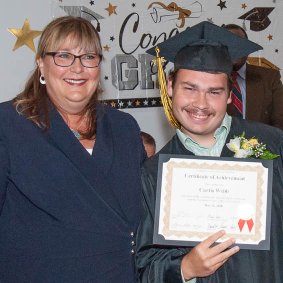 Student holding certificate