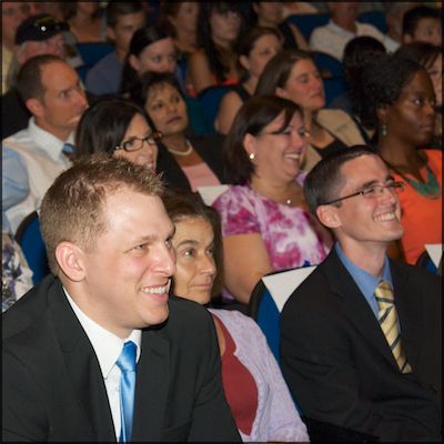 Audience members smiling