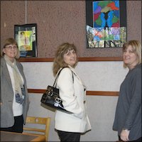 Visitors looking at artwork