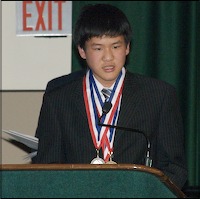 Larman Luo speaking at podium