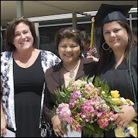 Graduate holding bouquet of flowers