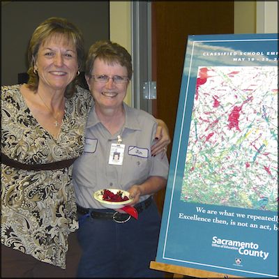 Employees with Classified Employee Week sign