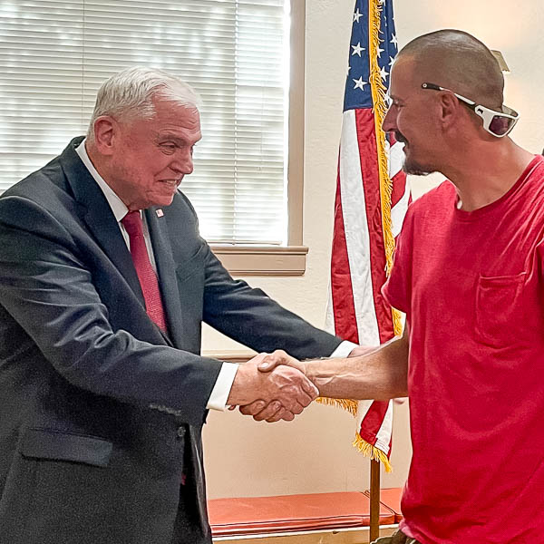 Superintendent shaking hands with graduate