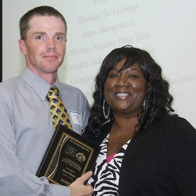 DRC graduate receiving plaque