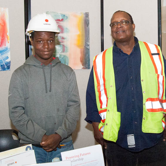 Employee wearing SMUD hard hat next to employee wearing high-vis vest